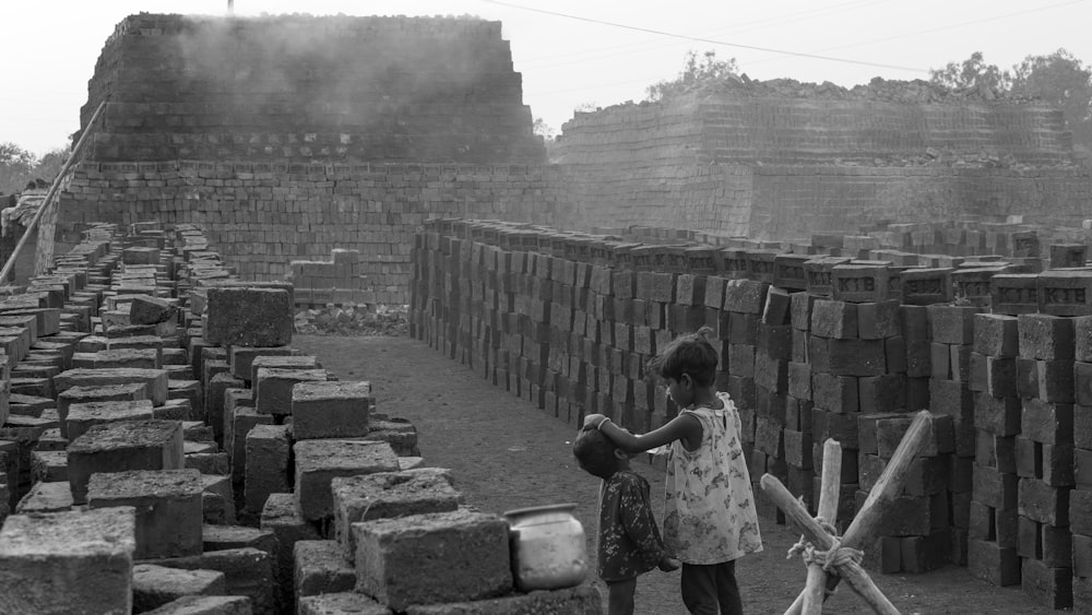 a person standing in front of a stone wall