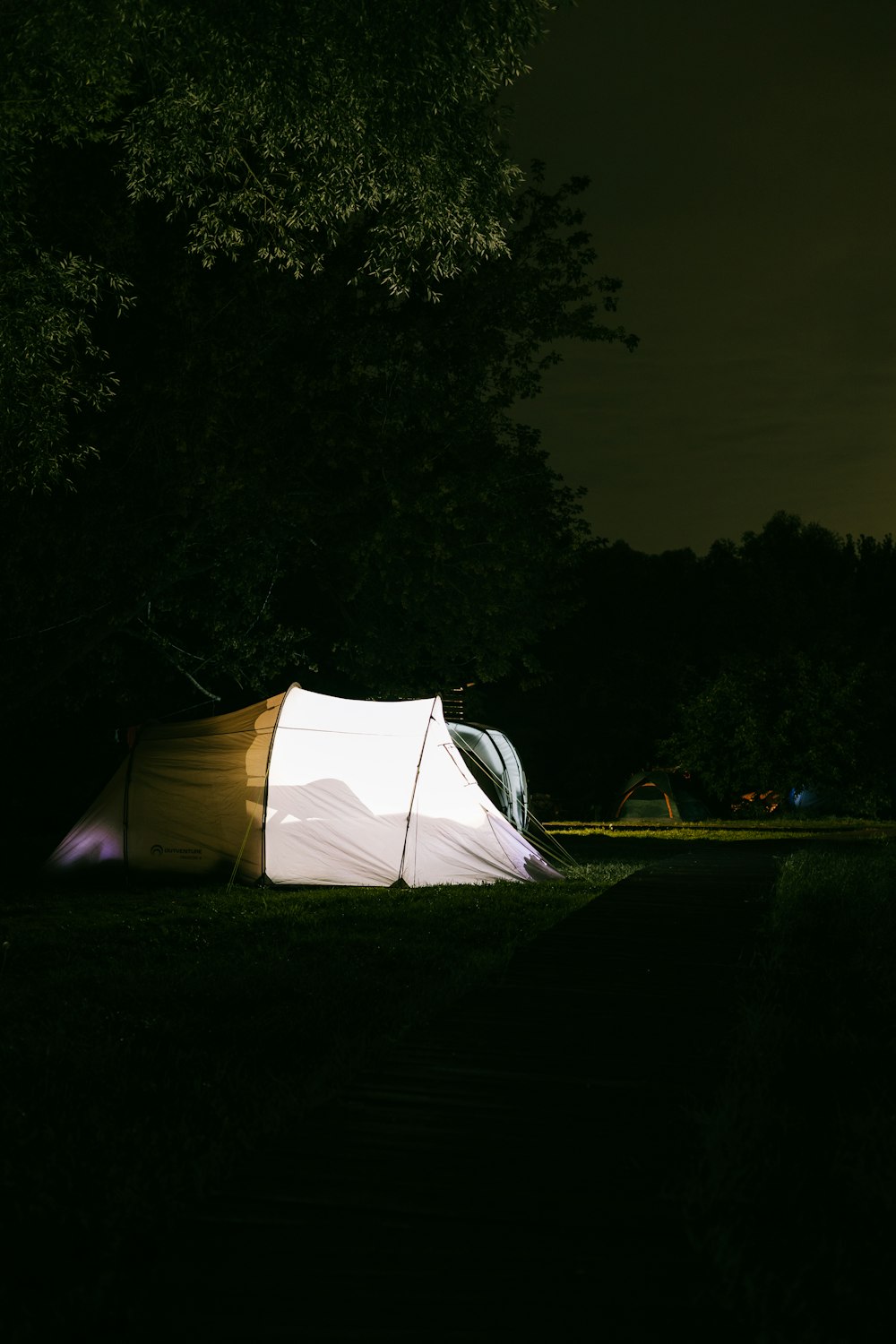 a tent in a field at night