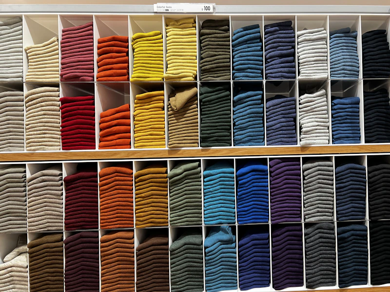 Shelves of neatly folded premium cotton socks in rich solid colors