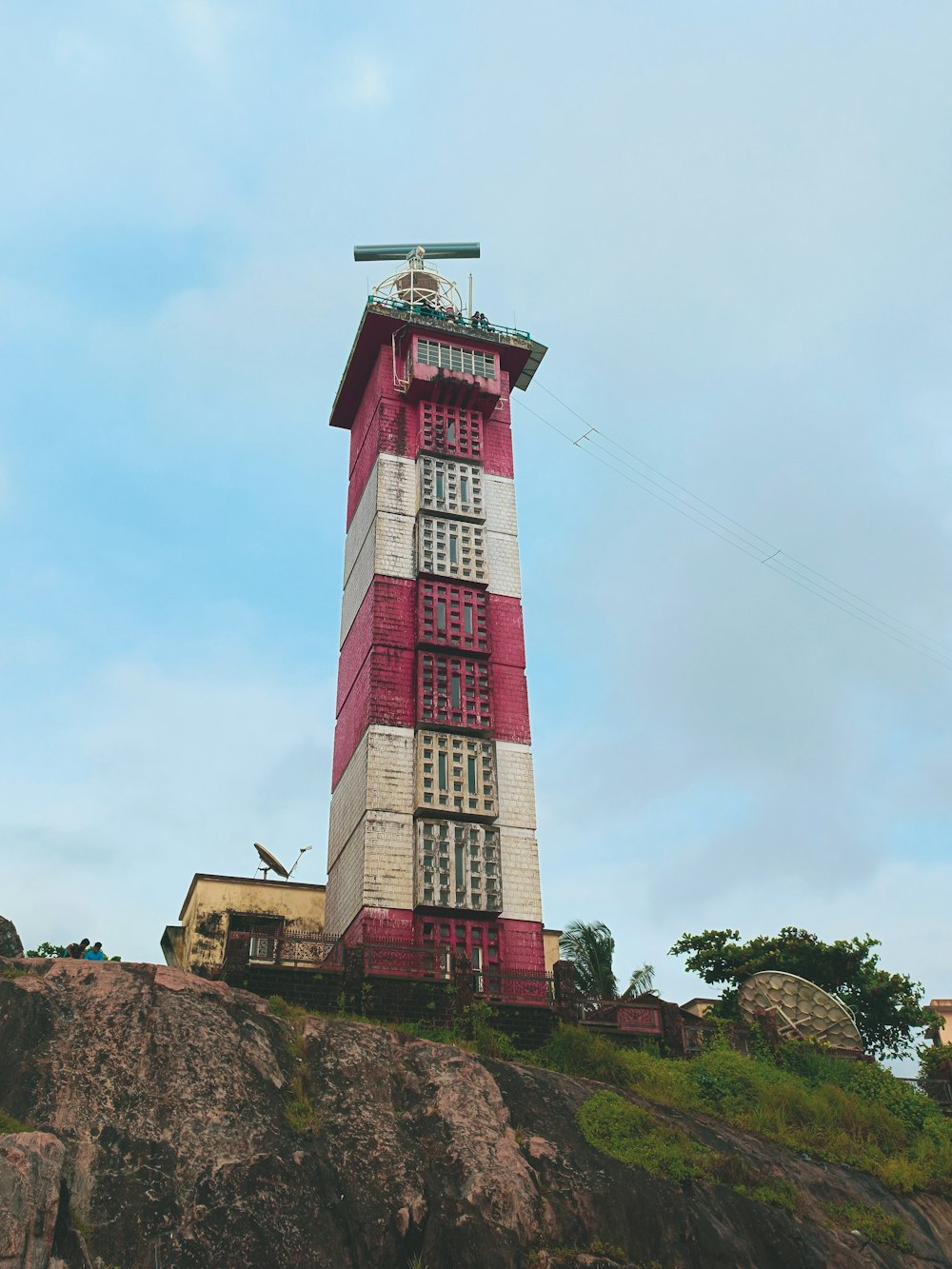 a lighthouse on a rocky hill