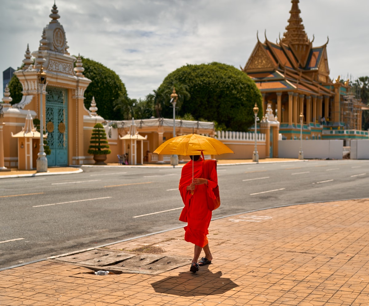 Riverside Daun Penh — Buddhist monk in red robe at a Phnom Penh temple in the historic colonial district near the Royal Palace