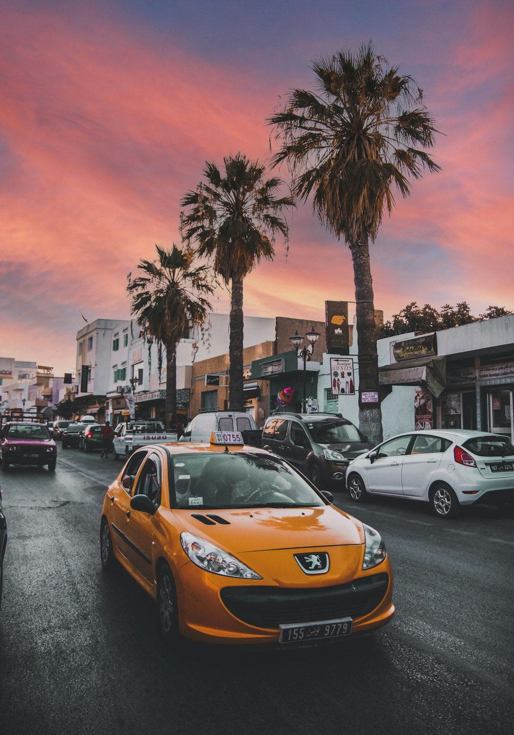 a yellow car on a street