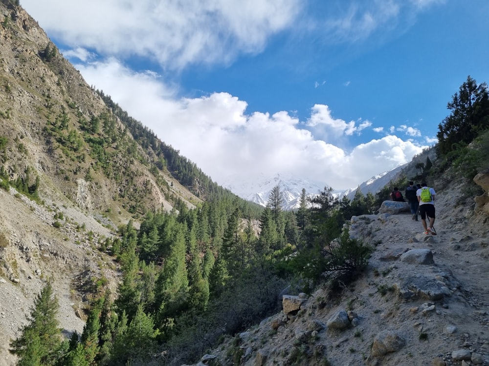 people hiking on a rocky mountain