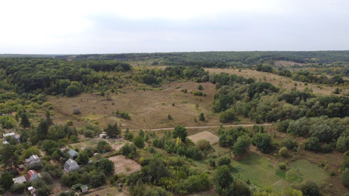 A panoramic view of a newly developed rural finca surrounded by lush greenery.