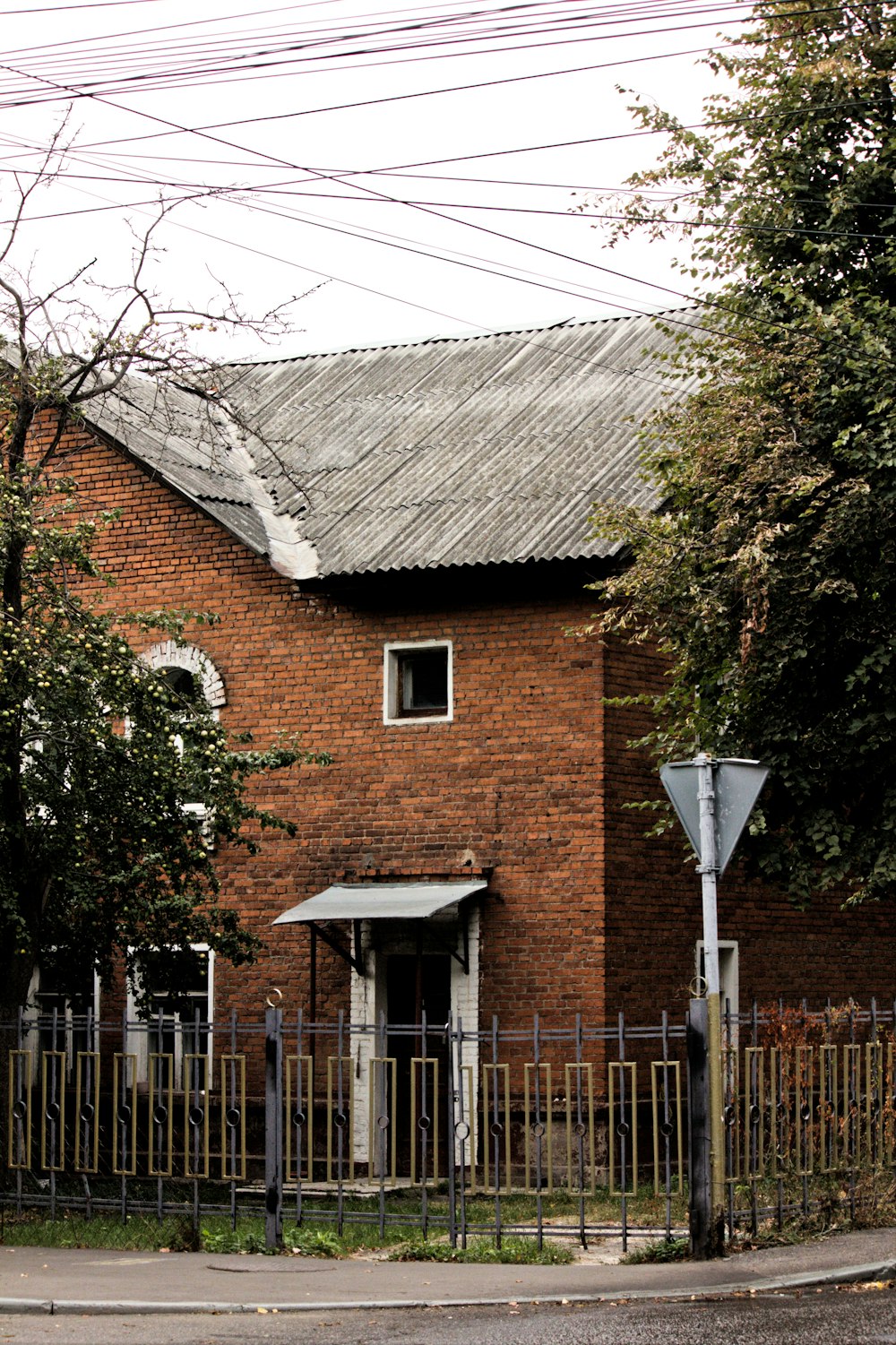 a brick building with a fence