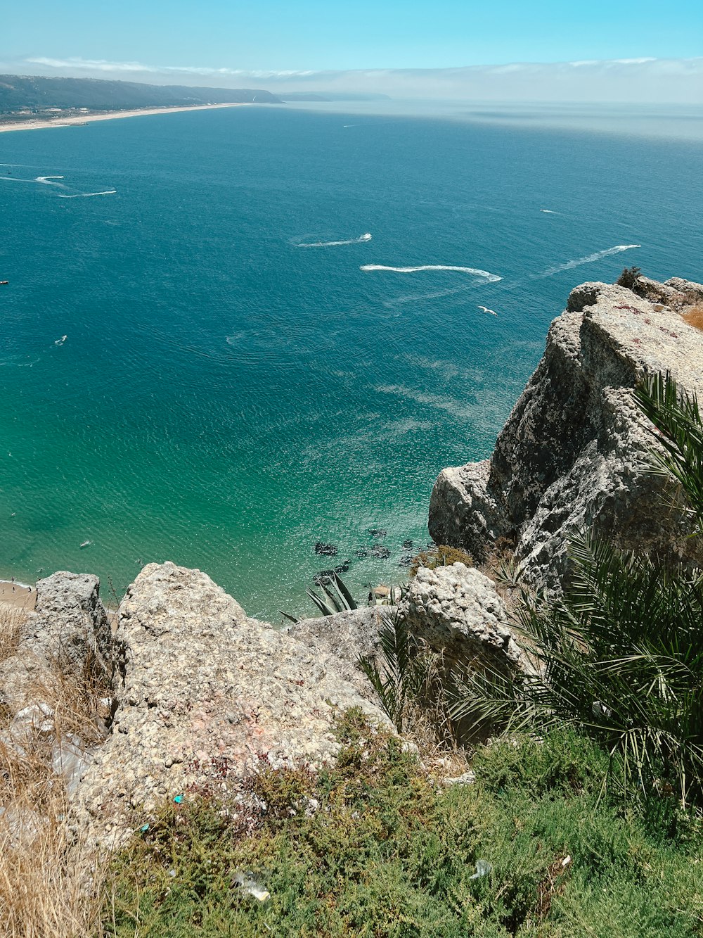 a cliff side with a body of water below