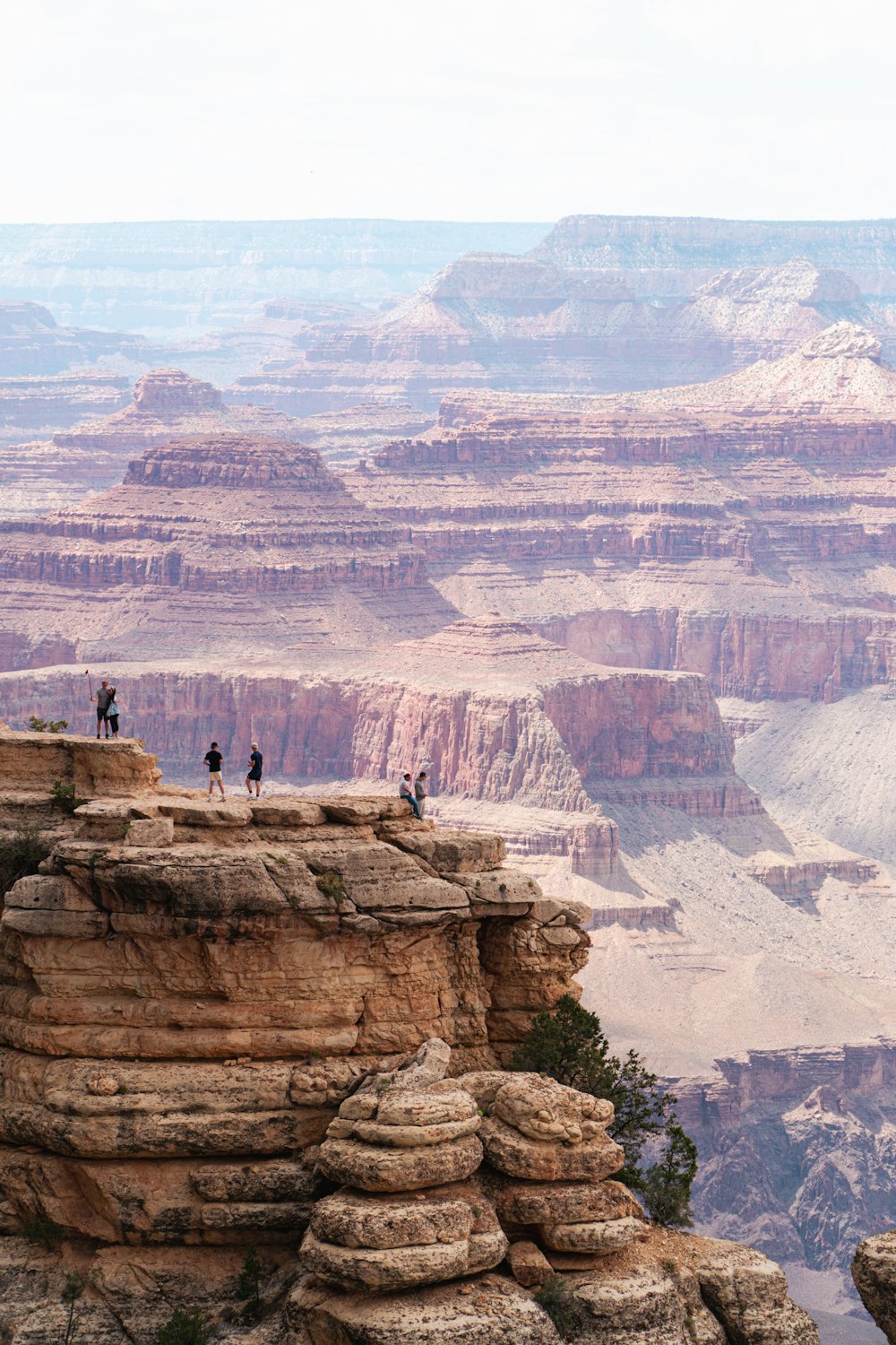 people standing on a rock ledge