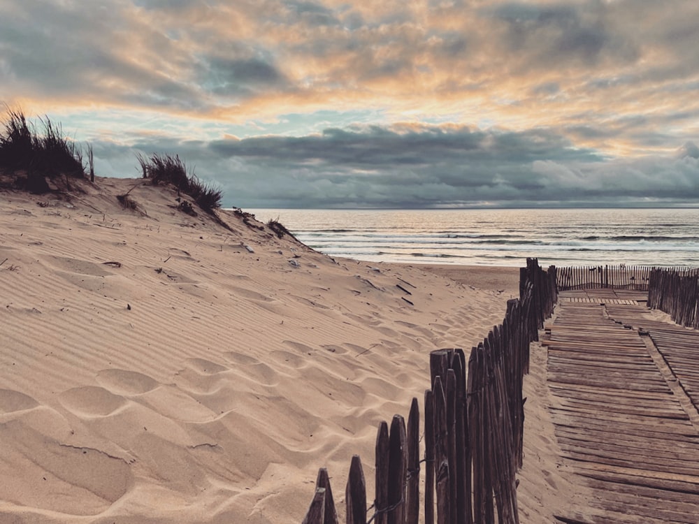 a wooden walkway on a beach