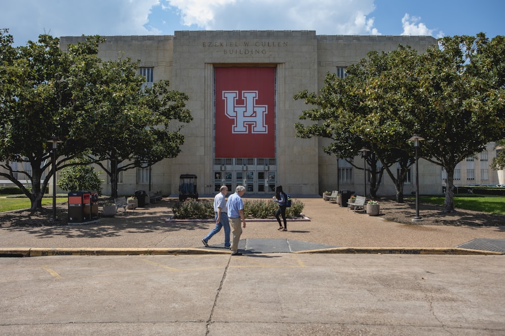 a few people walking outside of a building