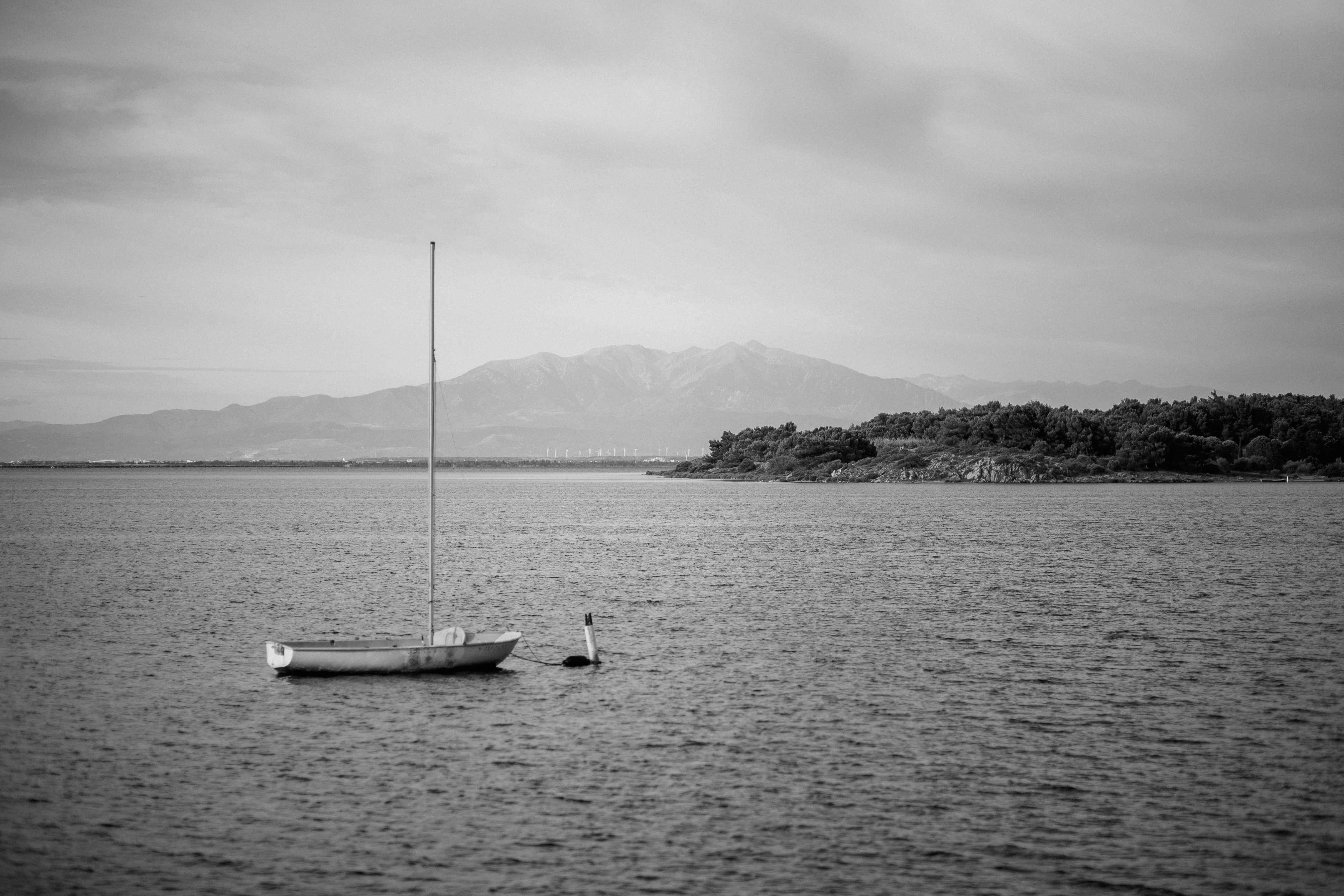 a couple of boats sit in the middle of a lake