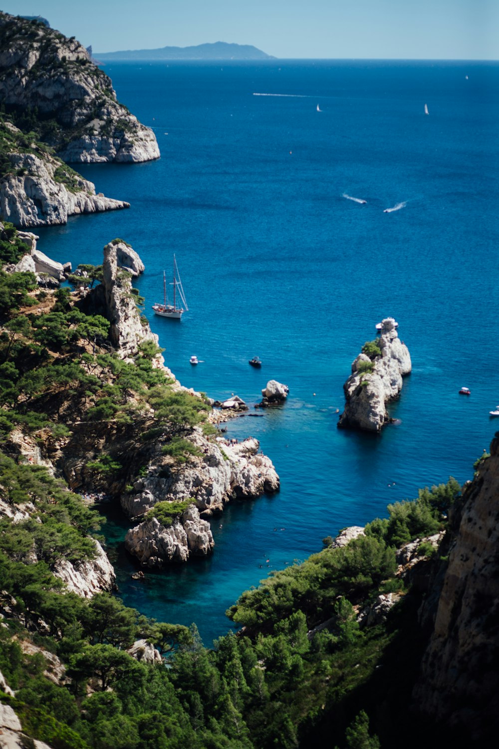 a rocky cliff with a body of water below