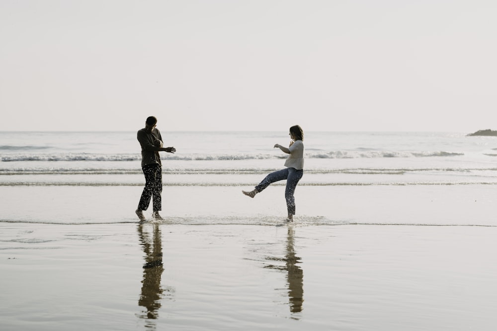 a man and a woman running on a beach