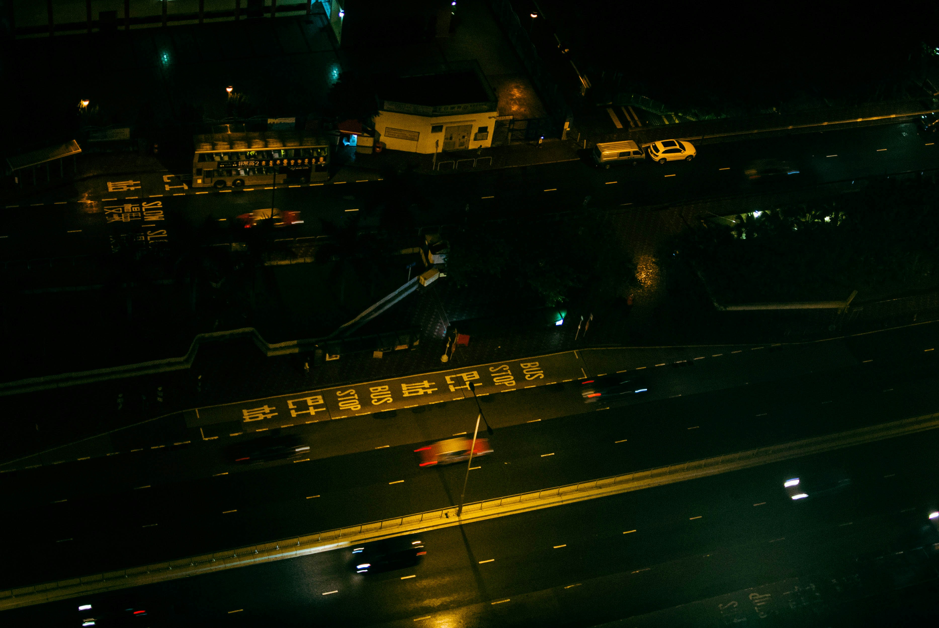 a street with cars and buildings at night
