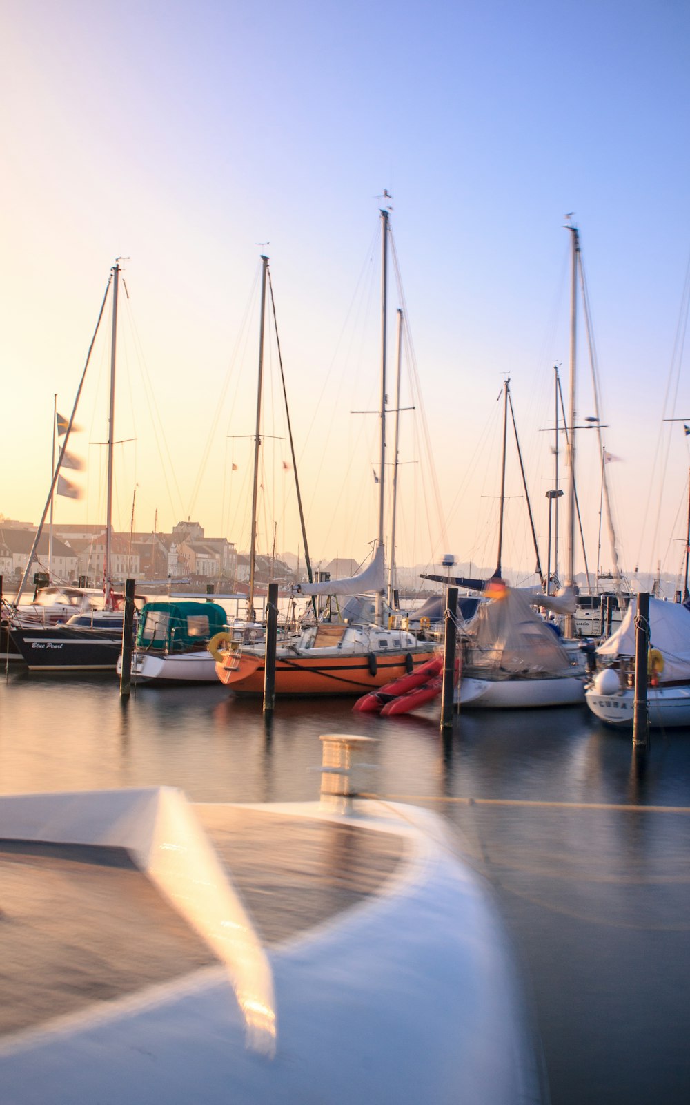 a group of boats sit in a harbor