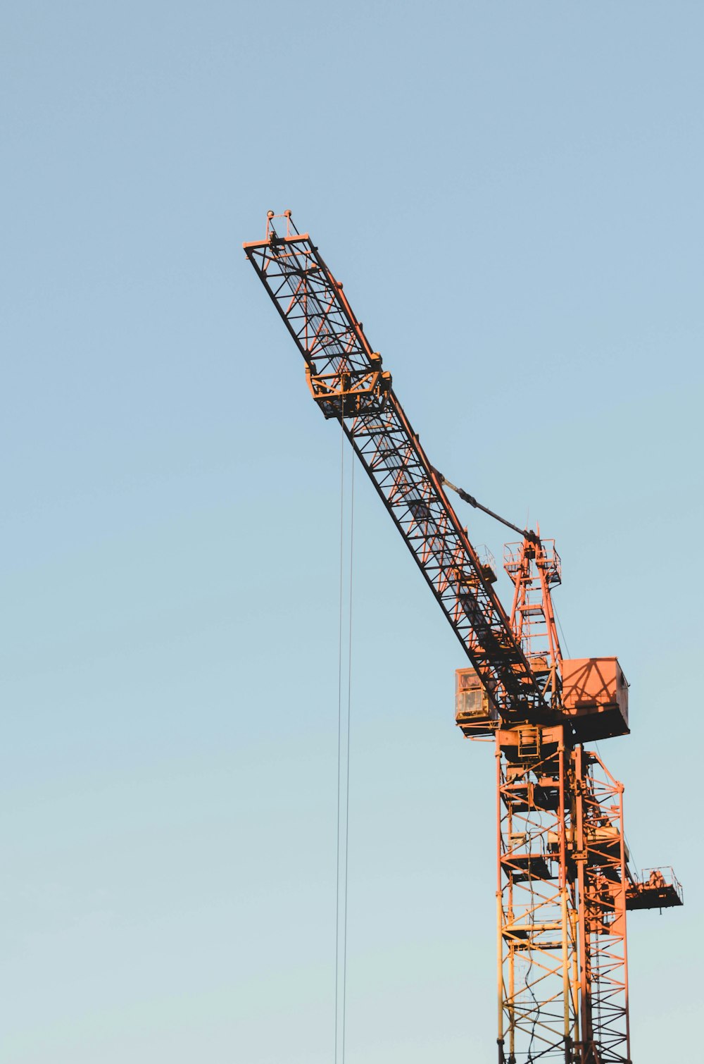 a large crane with a blue sky