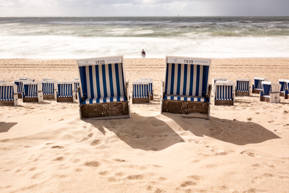 a row of beach chairs on a sandy beach