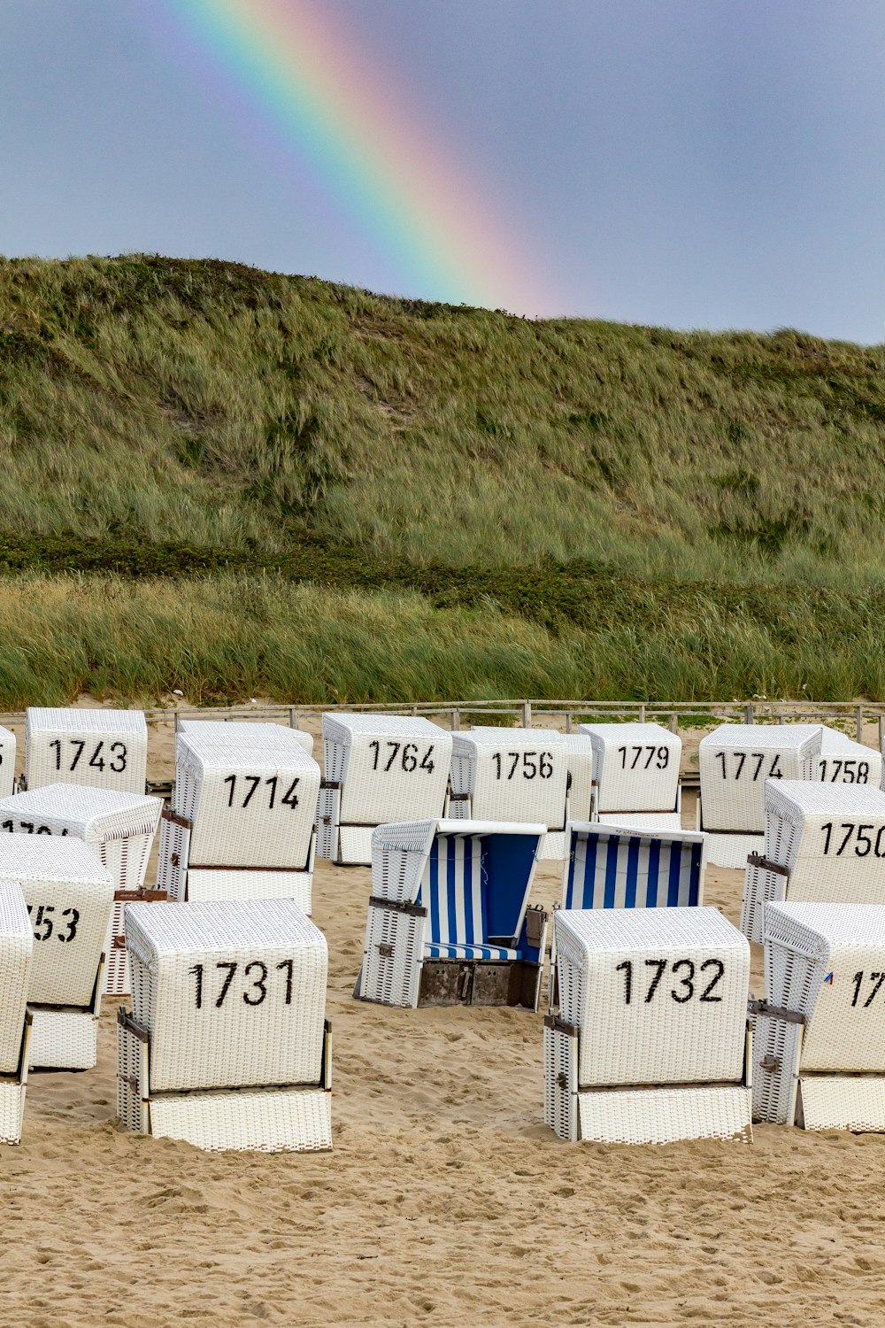 a group of white buildings with a rainbow in the background