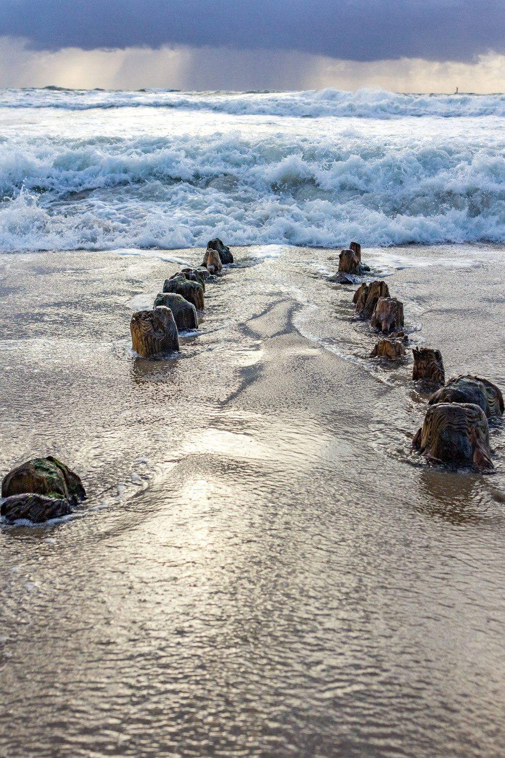 a beach with rocks and waves