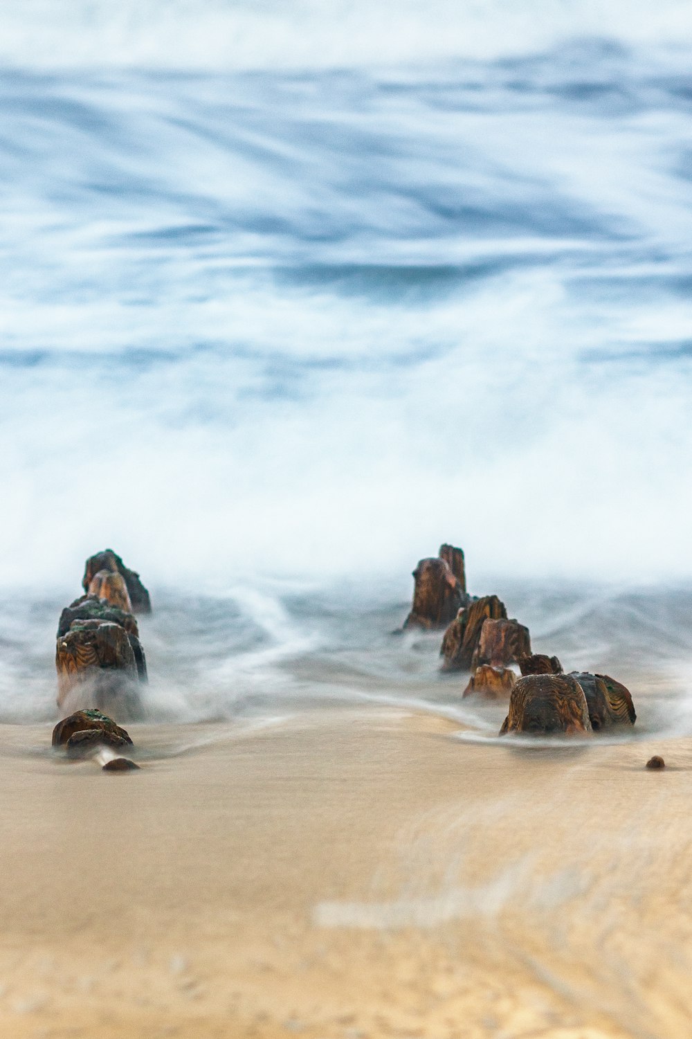 a rocky beach with waves crashing