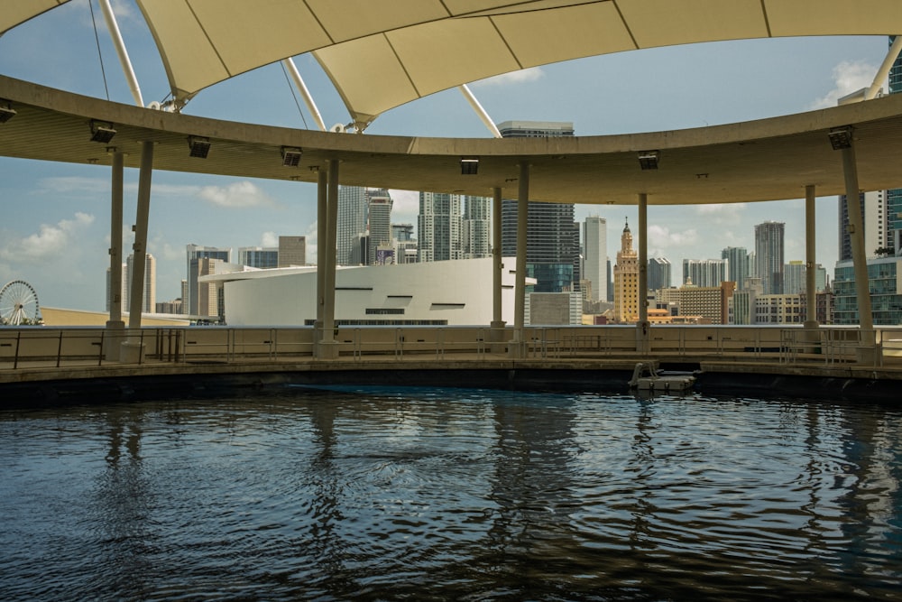 a body of water with a bridge and buildings in the background