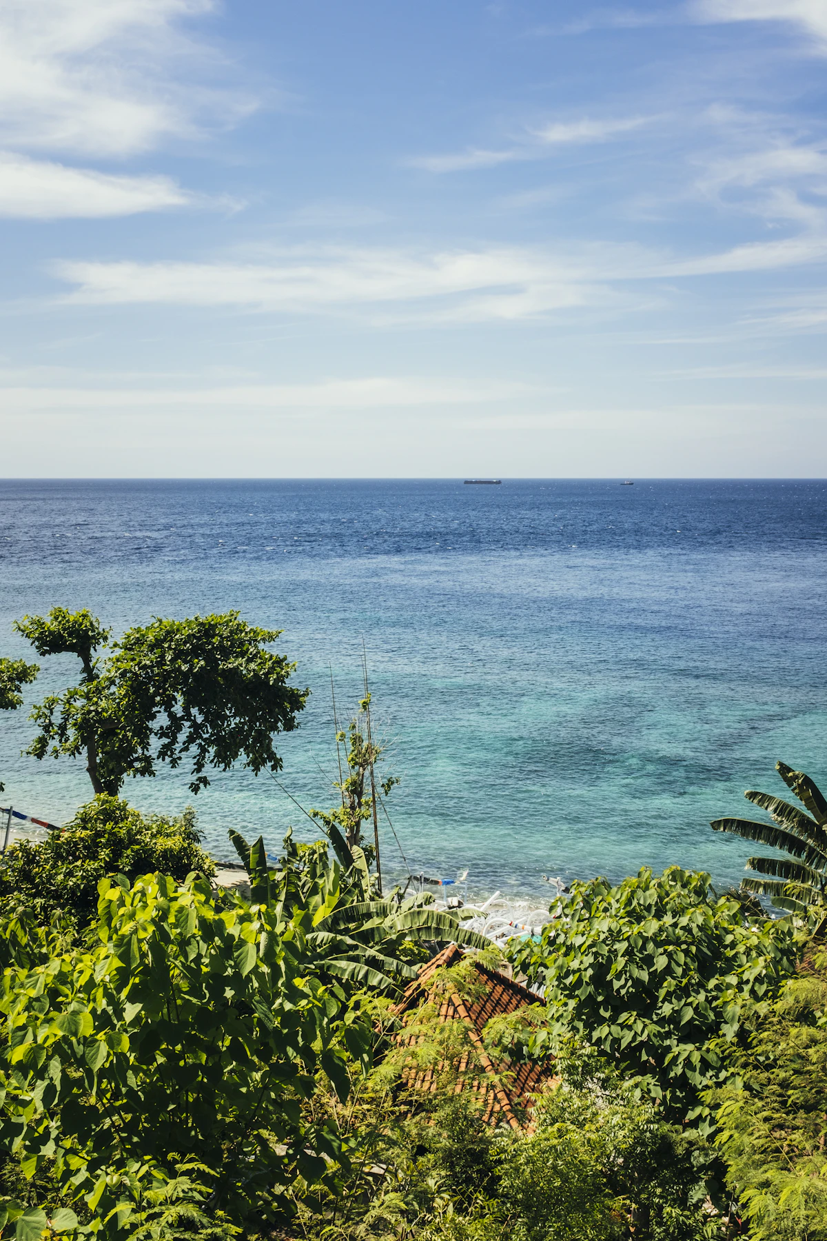 Traditional wooden outrigger boats and black sand bays beneath Mount Agung in Amed