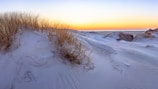 a snowy landscape with a sunset