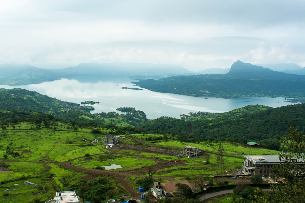 a landscape with a body of water and buildings by it