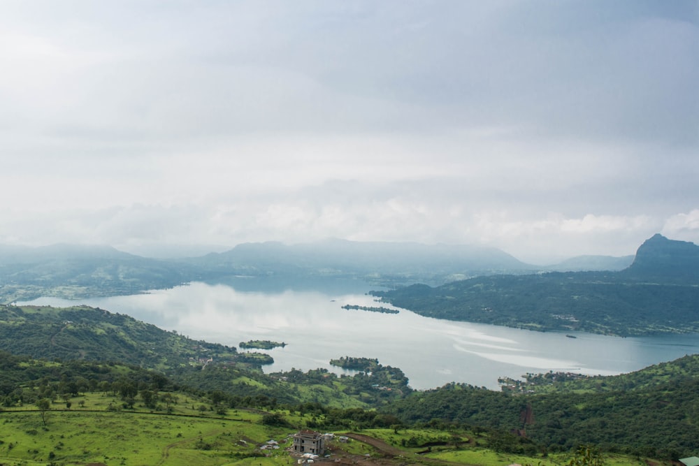 a body of water surrounded by hills and trees