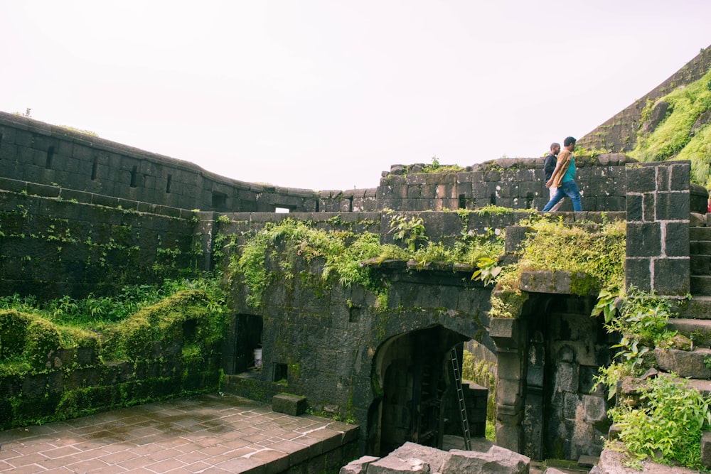 a person standing on a stone wall