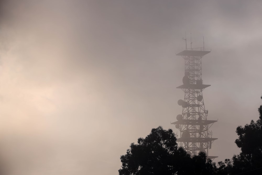 a tall tower with trees in the foreground