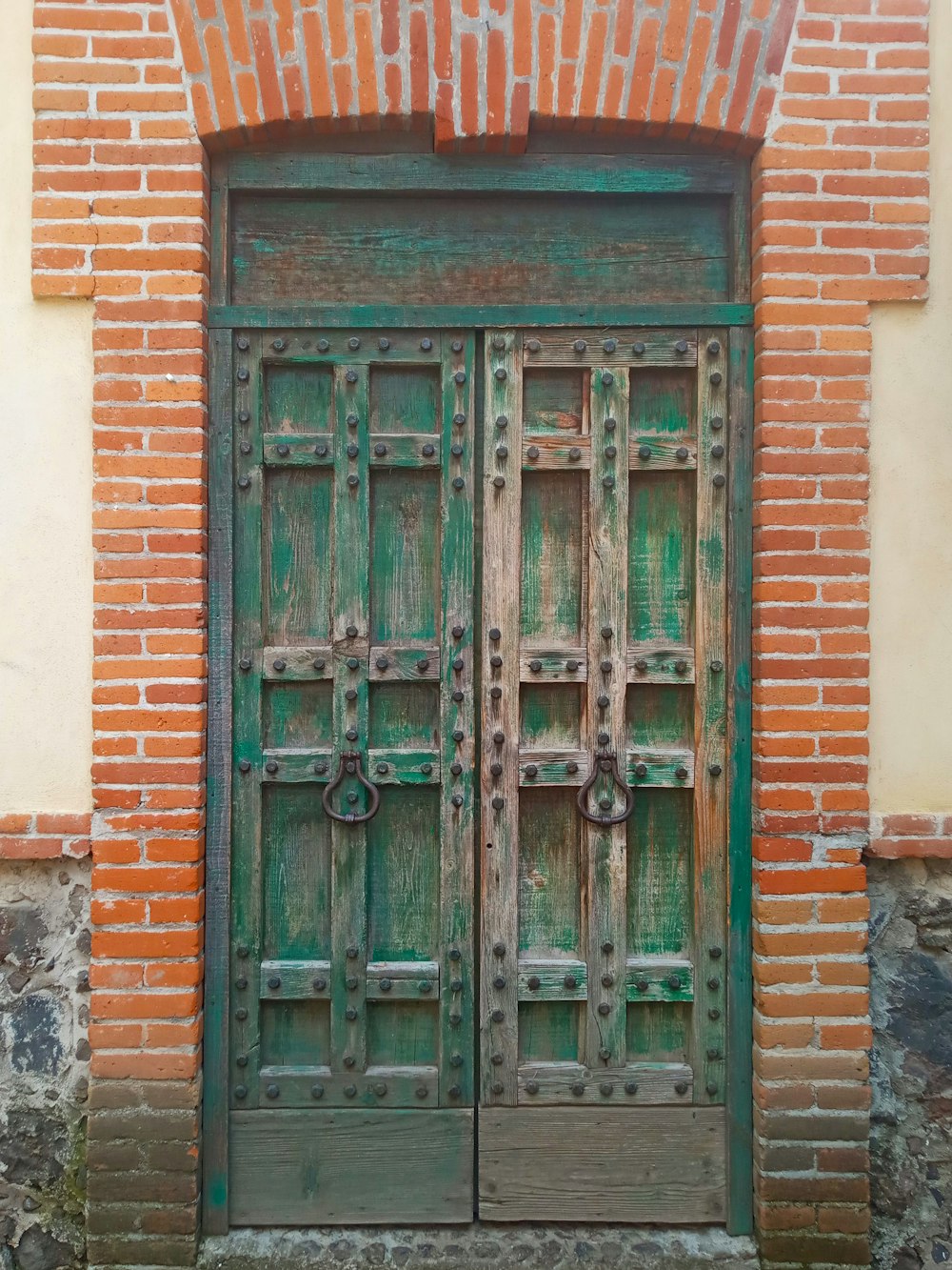 a green door on a brick building
