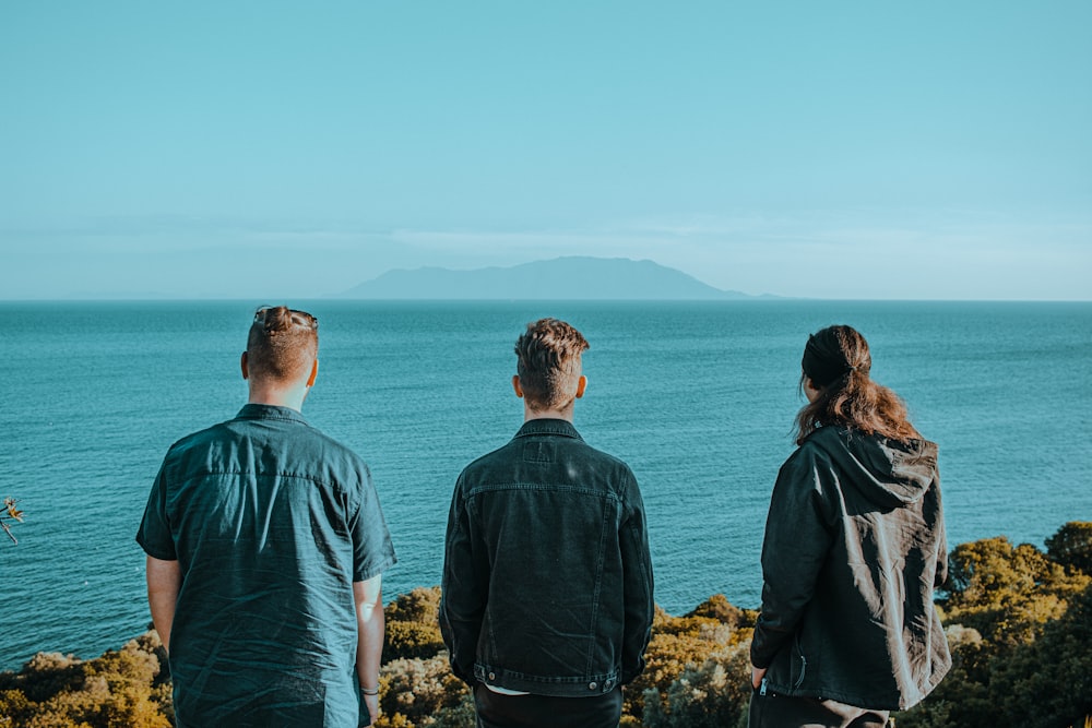 a group of people looking at the ocean