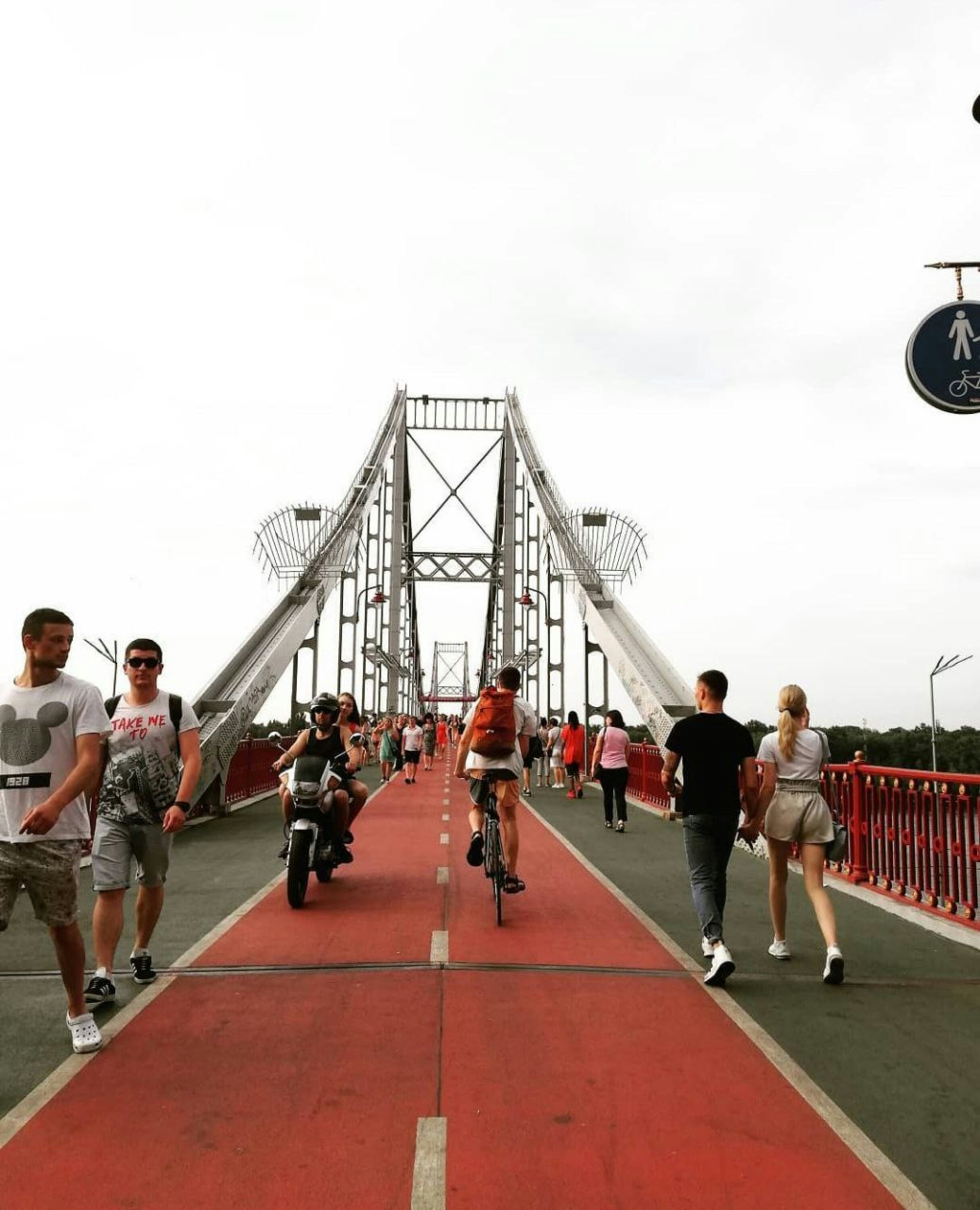 a group of people running on a bridge