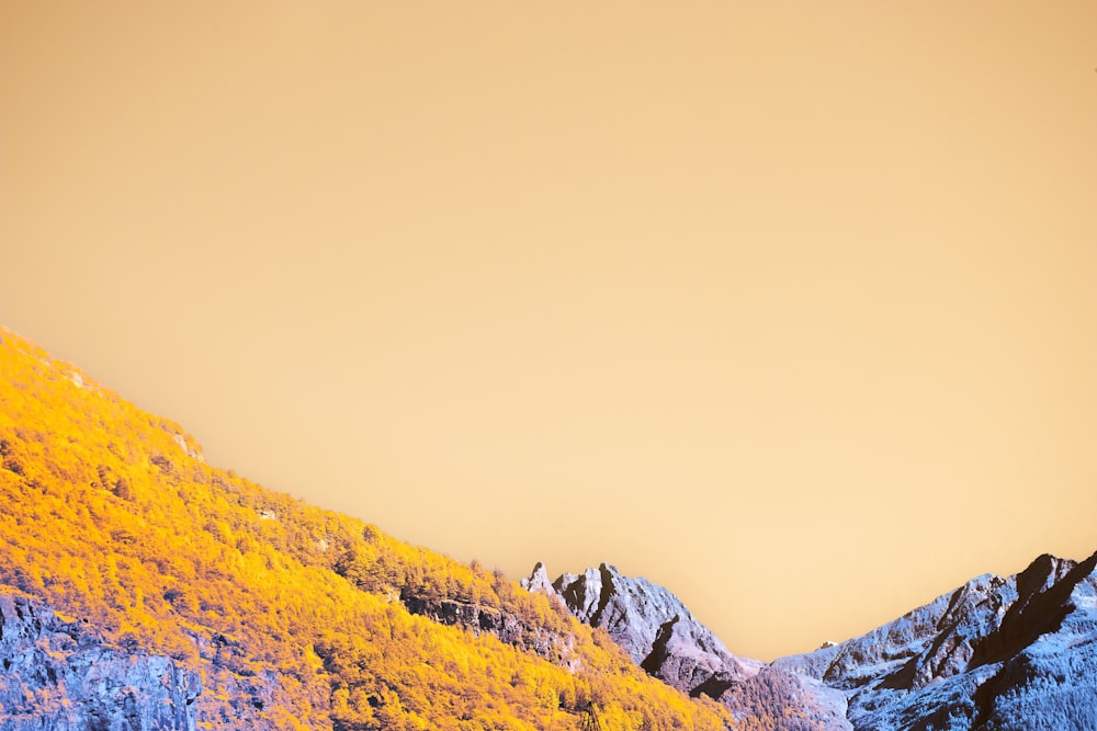 a snowy mountain with a blue sky