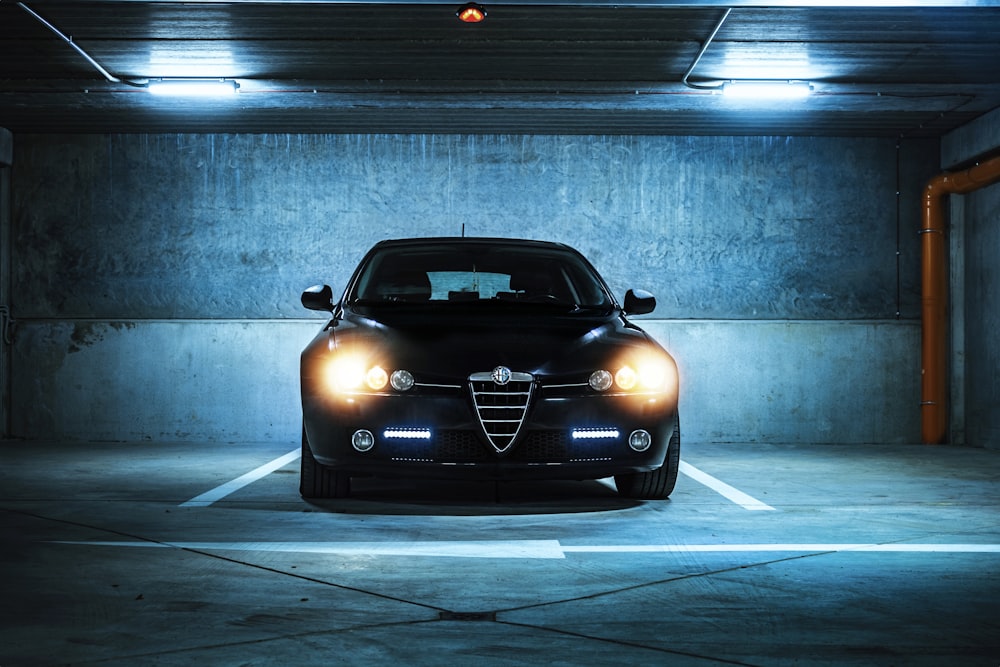 a black car parked in a parking garage