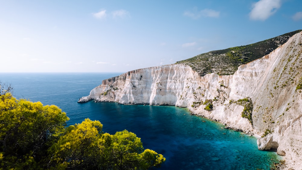 a cliff with a body of water below