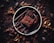 A rich, indulgent chocolate dessert is presented on a dark plate, drizzled with melted chocolate. Surrounding the dessert, several pieces of chocolate and cocoa beans are artfully scattered on a dark wooden surface, enhancing the image's decadent and luxurious feel.