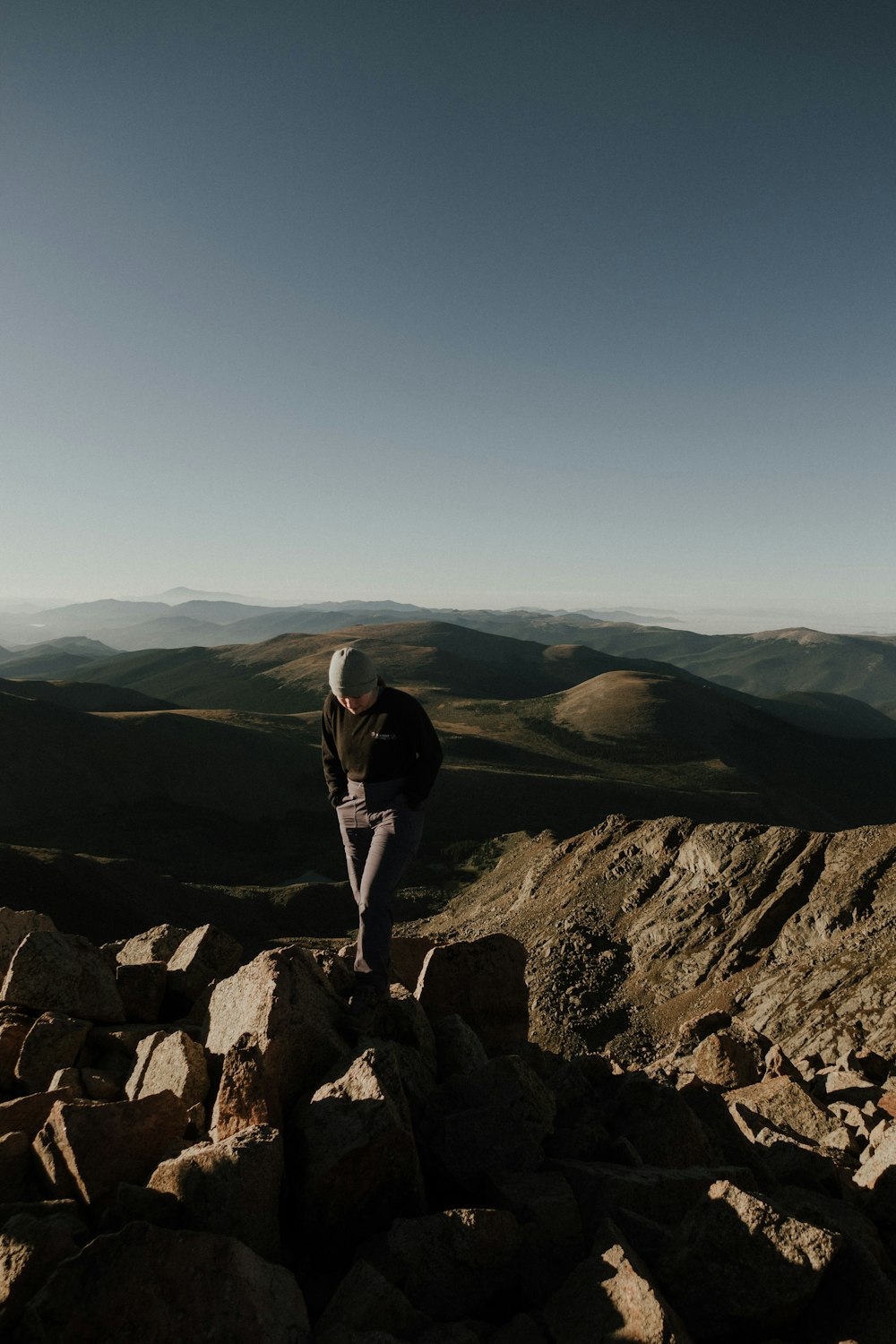 a person standing on a rocky hill