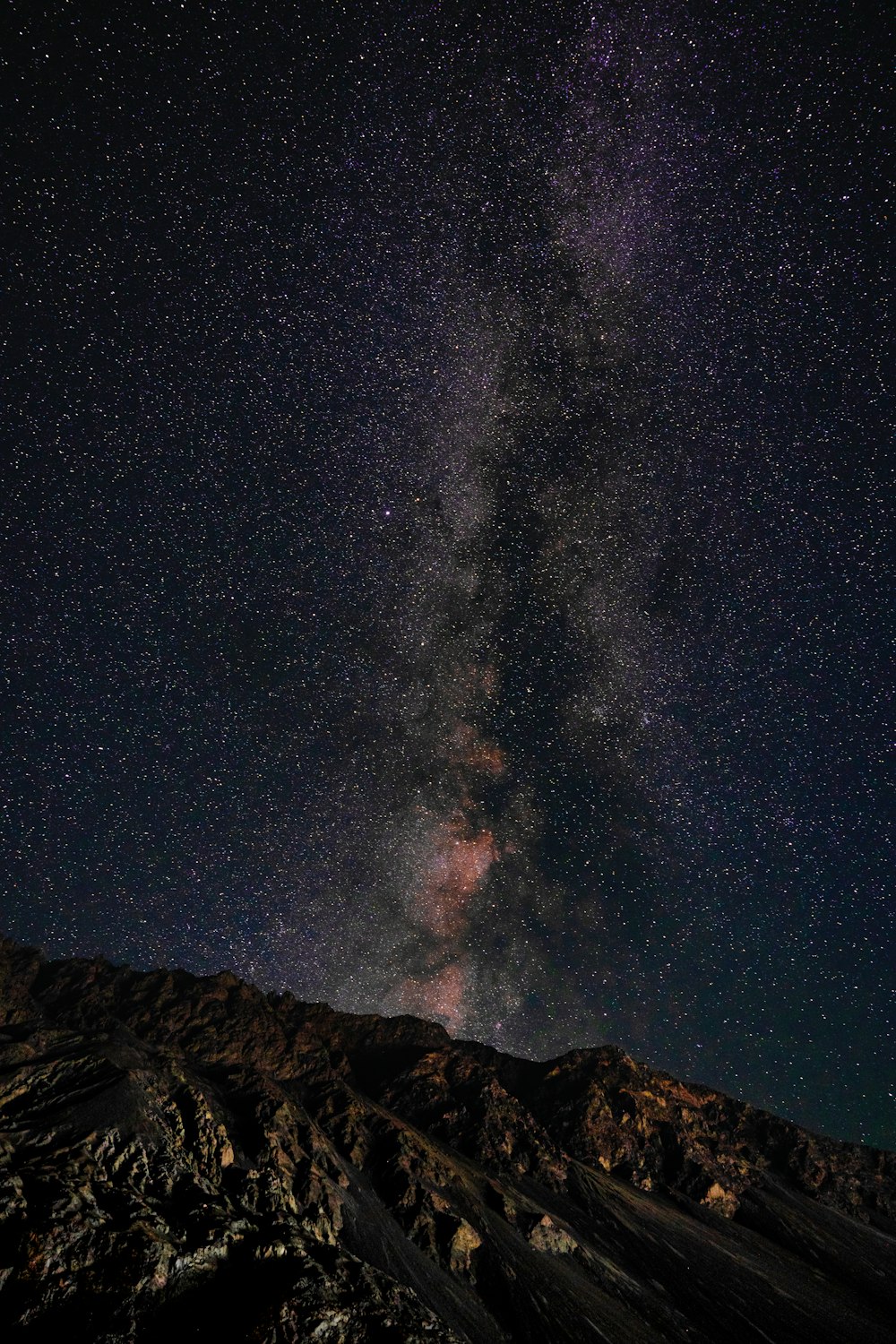 a mountain with a starry sky above it