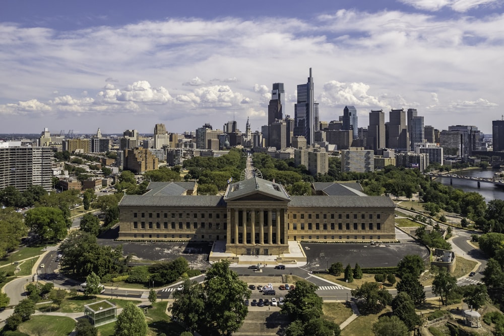 a large building with a city in the background