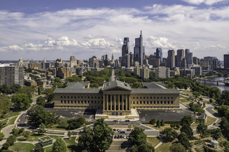 a large building with a city in the background