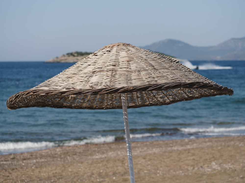 a straw umbrella on a beach