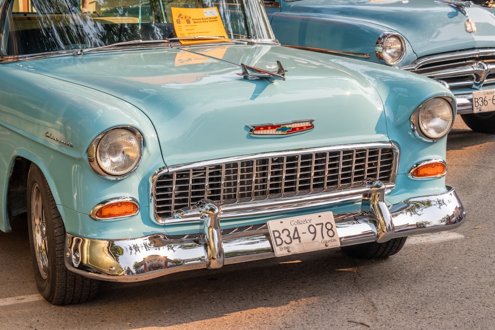 a blue car parked next to another car