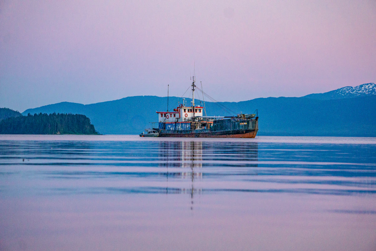 Boat on calm water at sunset
