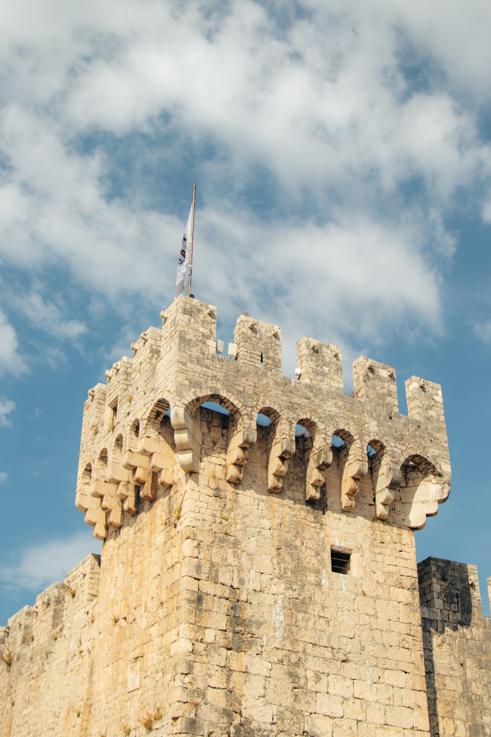 a stone castle with a flag on top