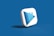 A 3D icon with a play button symbol and a book graphic is centered against a solid blue background. The icon is designed in white and shades of blue, with a modern and sleek appearance.