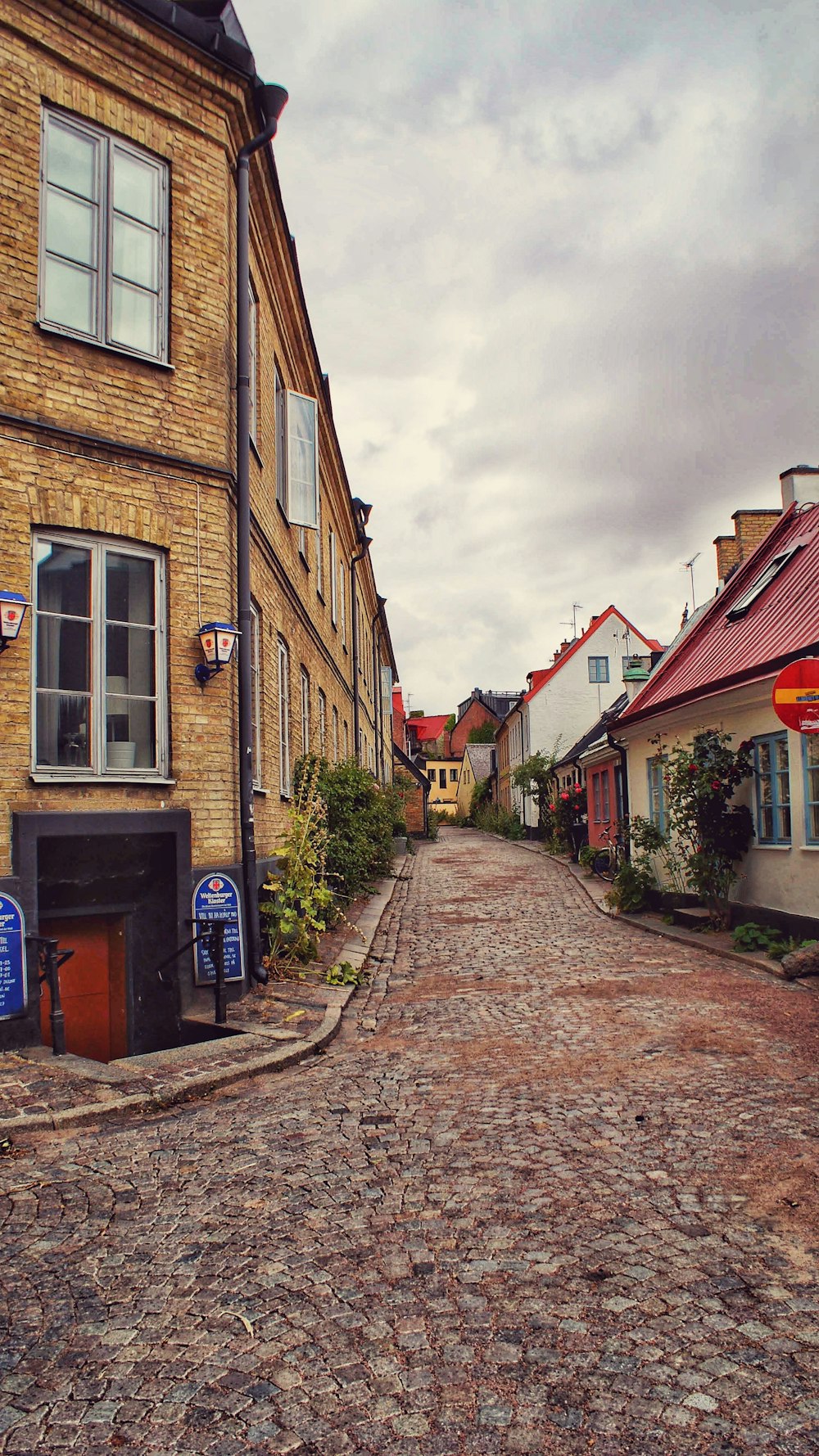 a cobblestone street with buildings on either side of it
