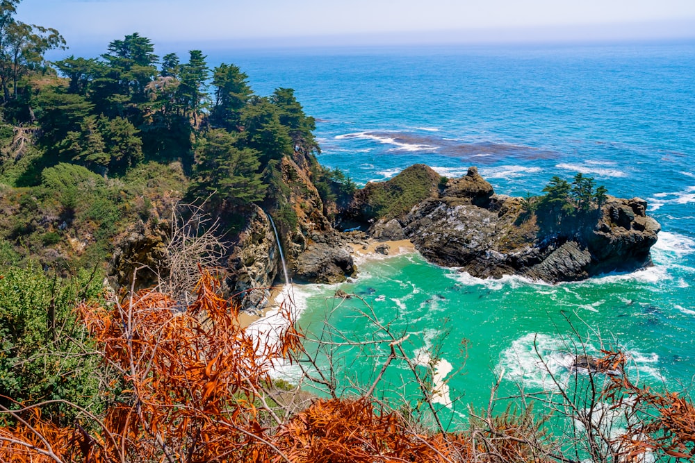 a rocky coast line with McWay Falls in the background