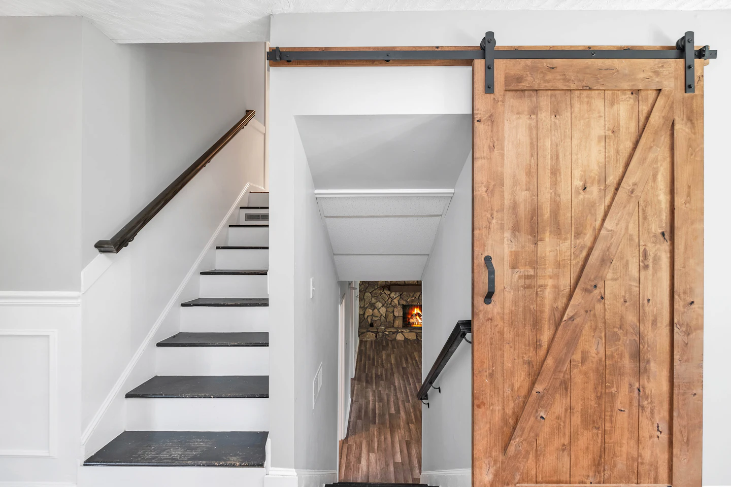 Stairway beside a sliding wood barn door