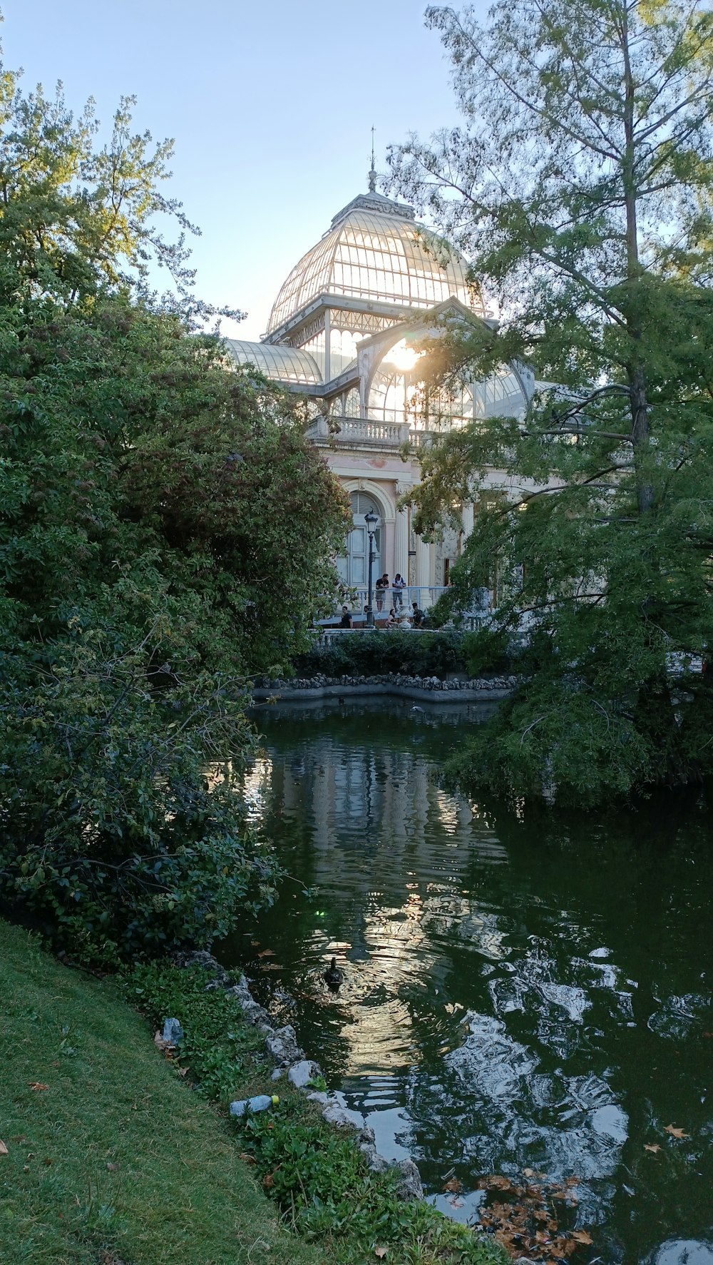 a building with a dome and a pond in front of it